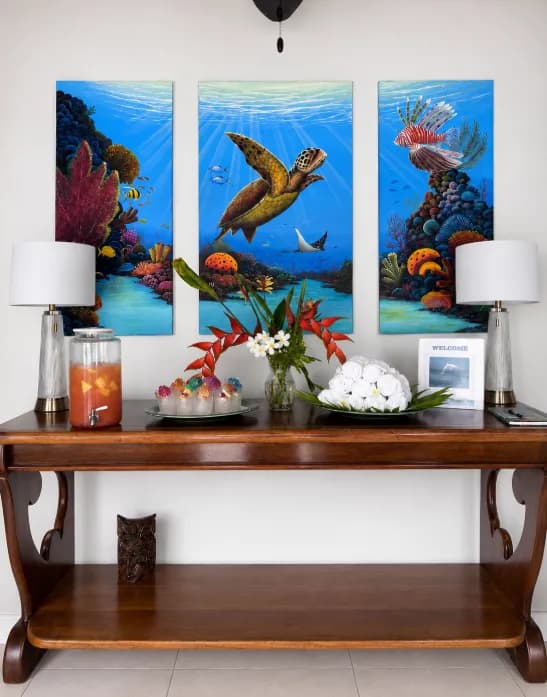 The full welcome console with lamps at each end and a sea turtle painting above it